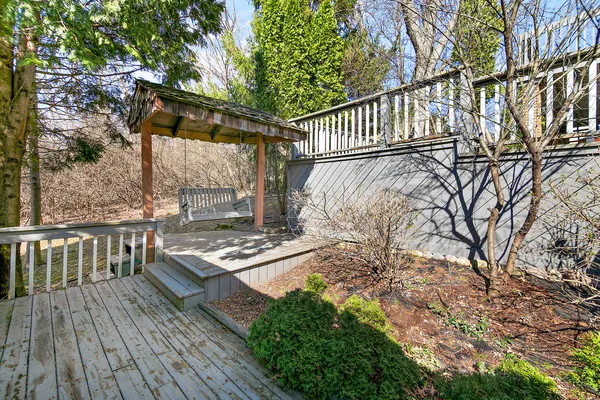 a view of a deck with couches and potted plants