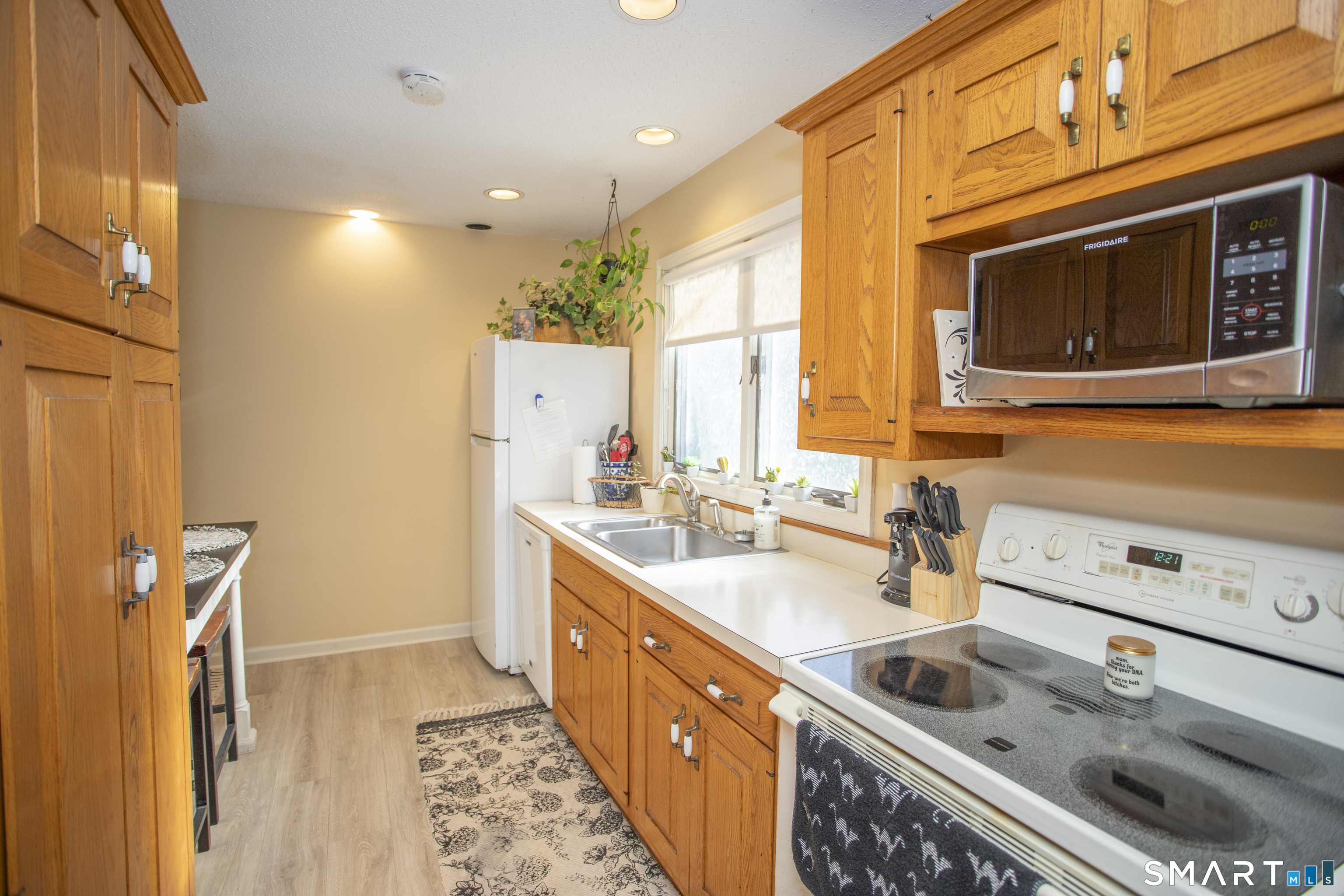 115 Ayers Point Road Old Saybrook, CT 06475 - Photo 11 of 34 a kitchen with a sink stove and microwave