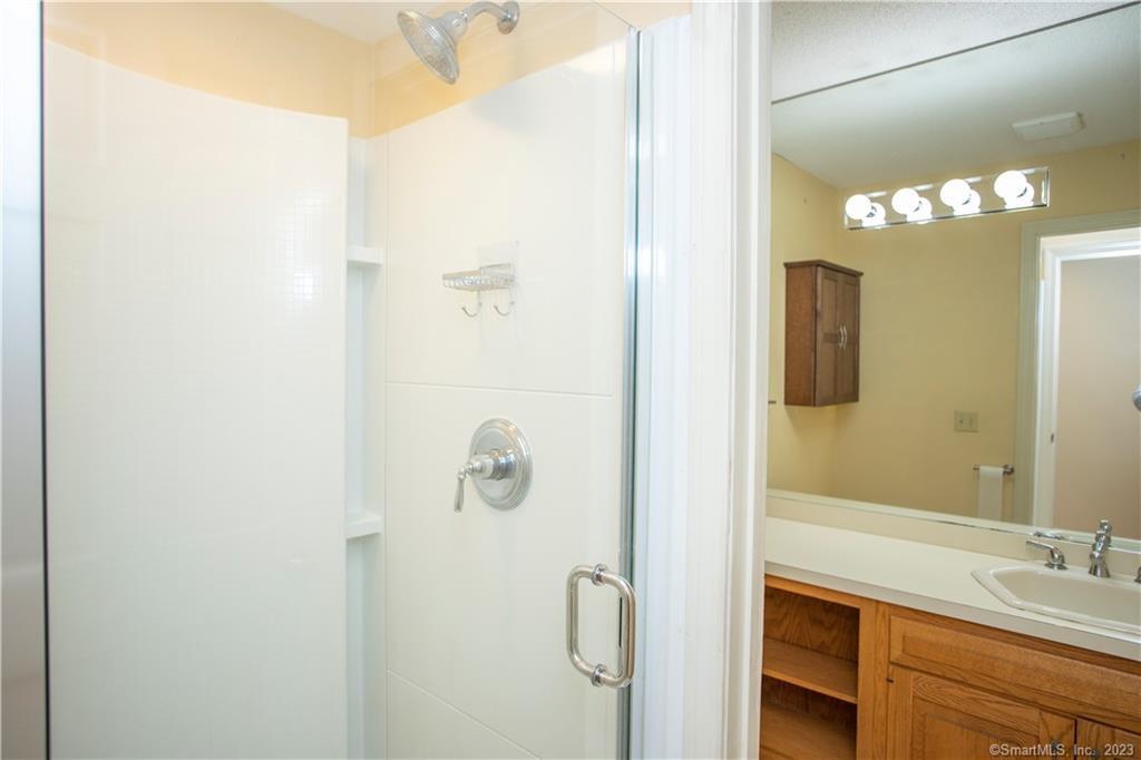 115 Ayers Point Road Old Saybrook, CT 06475 - Photo 13 of 34 a bathroom with a sink and mirror