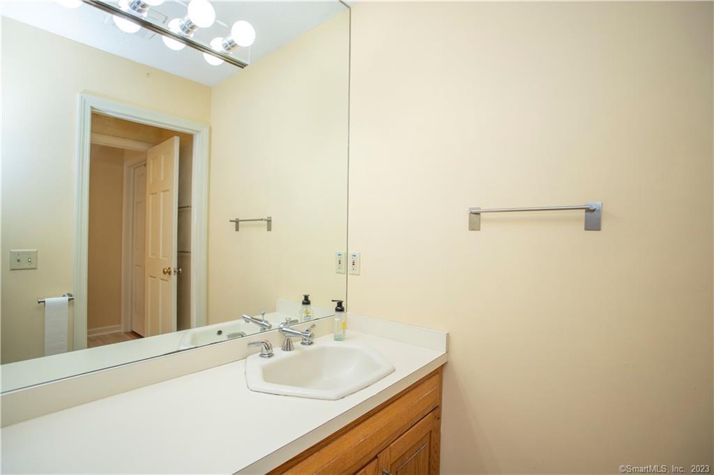 115 Ayers Point Road Old Saybrook, CT 06475 - Photo 14 of 34 a bathroom with a sink and a mirror