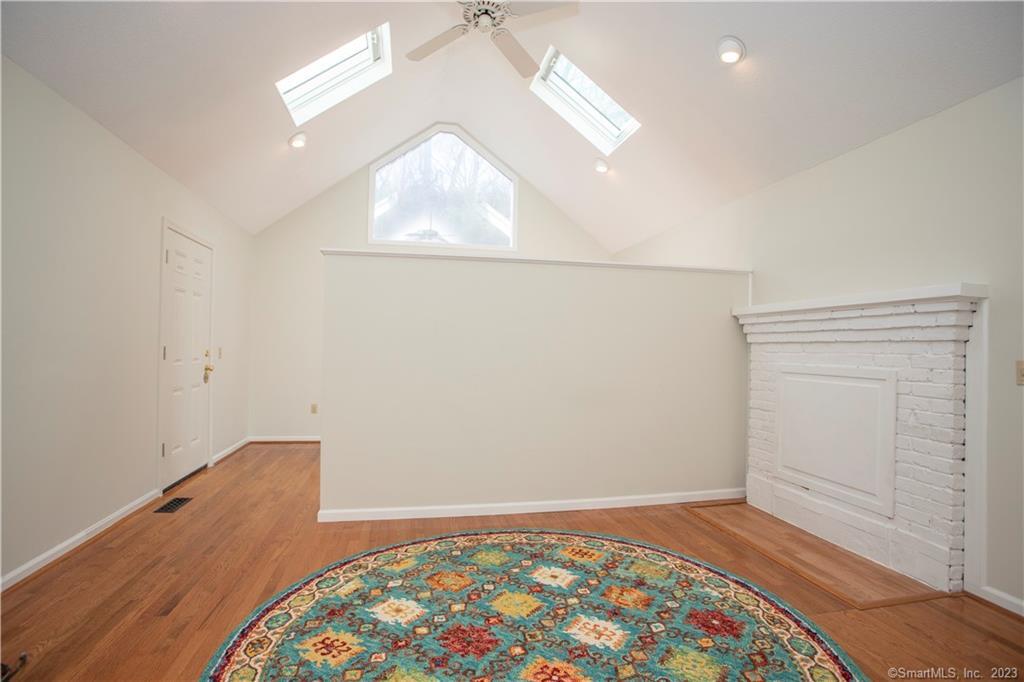 115 Ayers Point Road Old Saybrook, CT 06475 - Photo 20 of 34 an empty room with wooden floor and windows