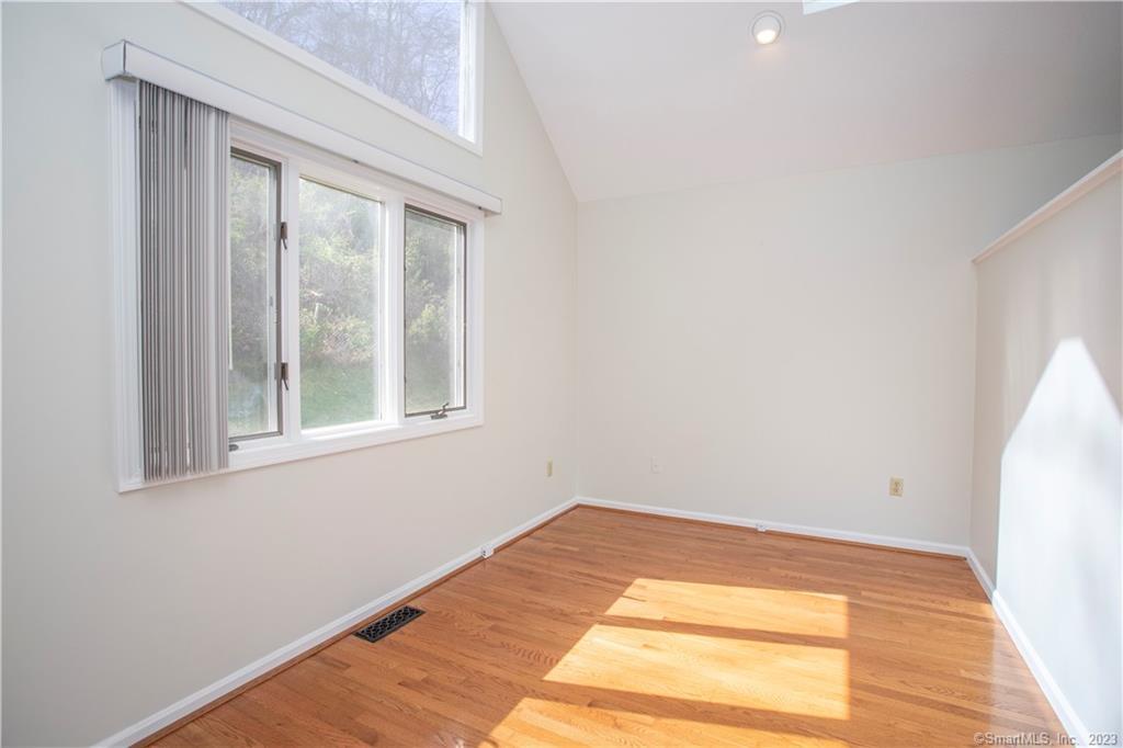 115 Ayers Point Road Old Saybrook, CT 06475 - Photo 22 of 34 a view of an empty room with wooden floor and a window