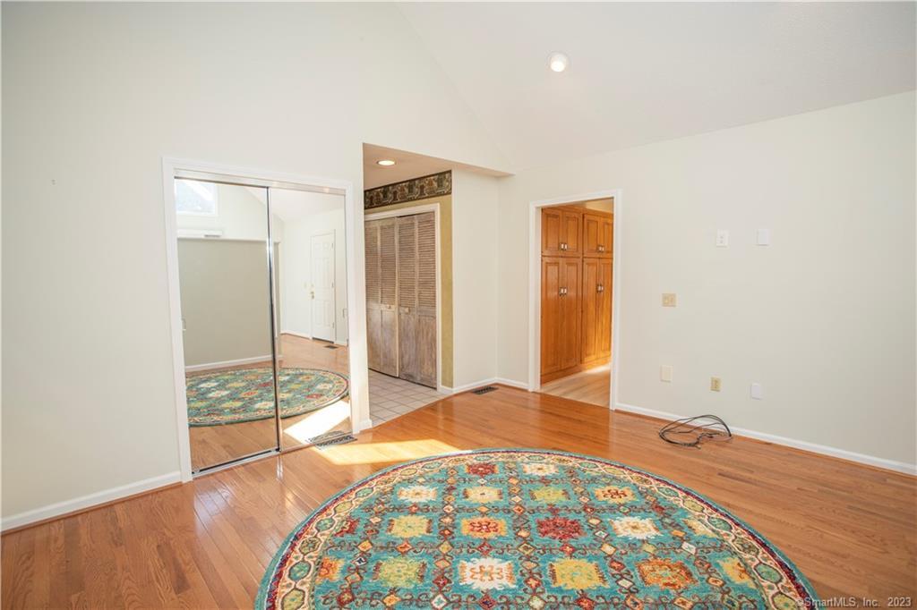 115 Ayers Point Road Old Saybrook, CT 06475 - Photo 27 of 34 a bedroom with a bed and a painting on the wall