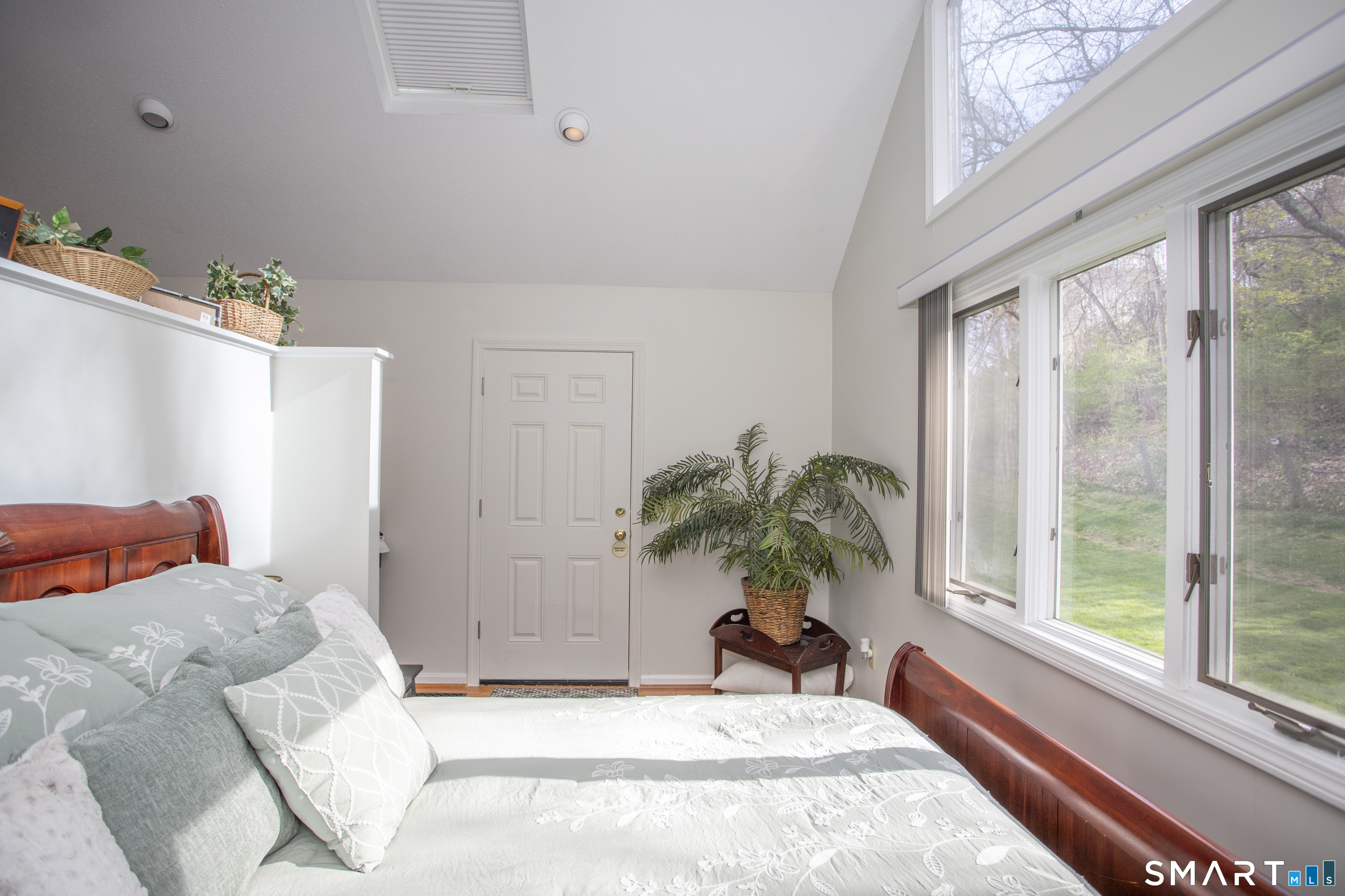 115 Ayers Point Road Old Saybrook, CT 06475 - Photo 10 of 34 a bedroom with a large bed and a large window