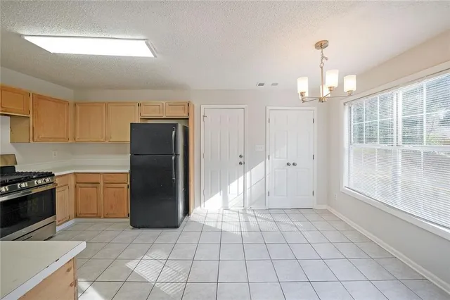 a kitchen with a refrigerator a stove and a sink
