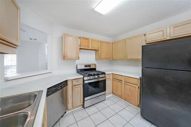 a kitchen with a stove sink and refrigerator