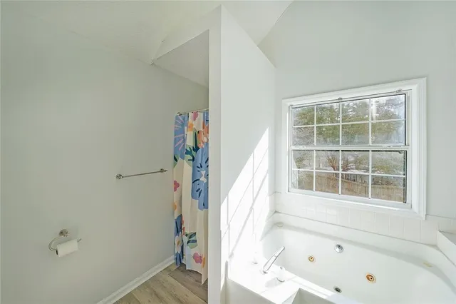 a bathroom with a bathtub and a shower