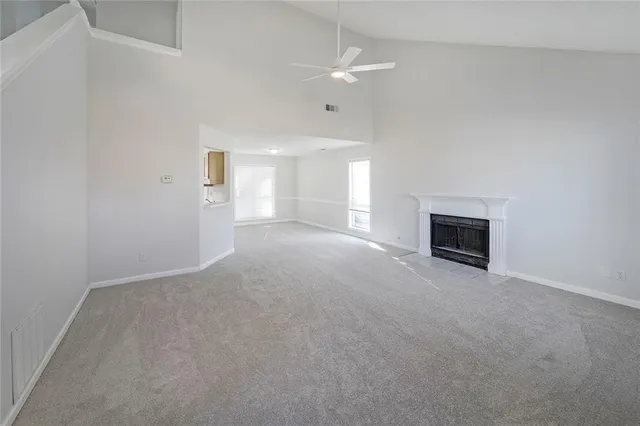 a view of a livingroom with an empty space and a fireplace