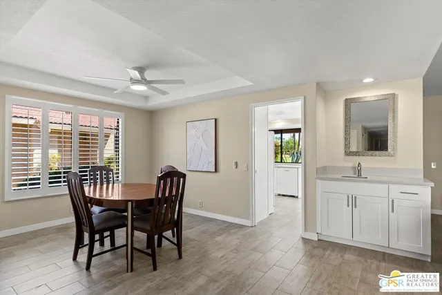 a view of a a dining room with furniture window and wooden floor