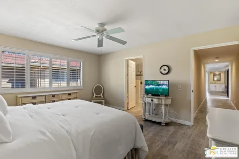 a bedroom with a large bed and a chandelier