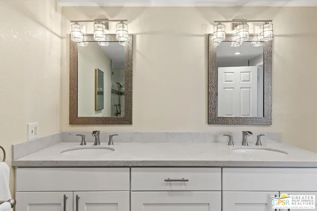 a bathroom with a sink double vanity and a mirror