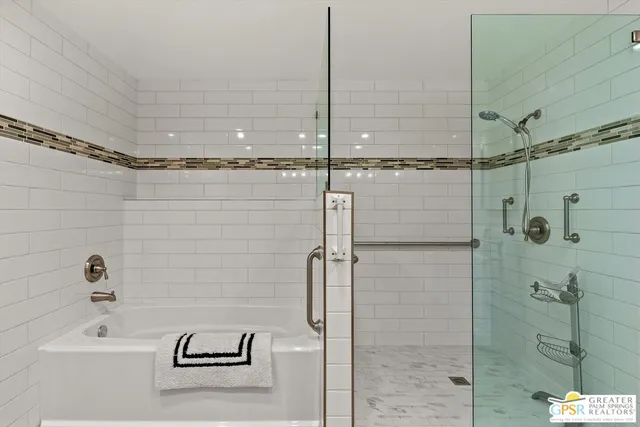 a bathroom with a bathtub and a shower