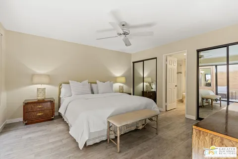 a spacious bedroom with a bed and ceiling fan