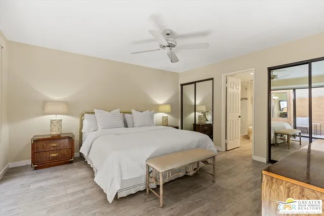 a spacious bedroom with a bed and ceiling fan