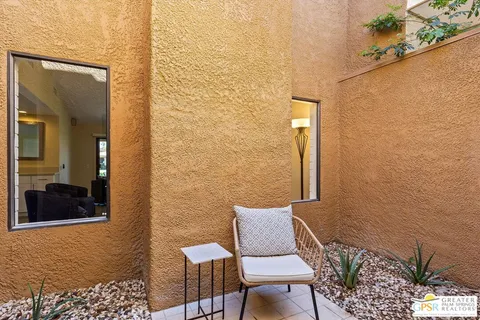 a view of a balcony with furniture and a potted plant