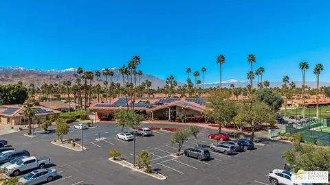 an aerial view of a house with garden space and mountain view in back
