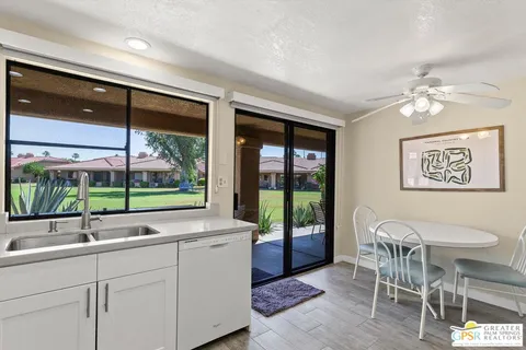 a living room with a sink and glass door