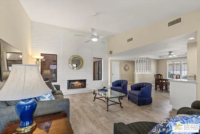 a living room with furniture and fireplace