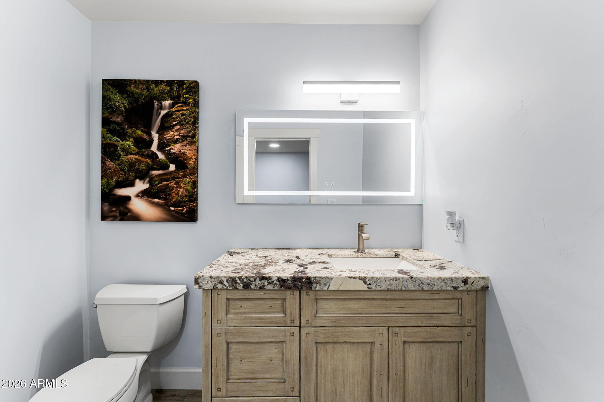 5055 Townsend-Winona Road Flagstaff, AZ 86004 - Photo 24 of 34 a bathroom with a granite countertop toilet sink and mirror
