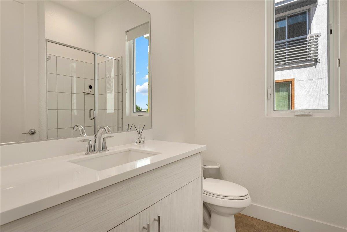 7961 Regional Common Dublin, CA 94568 - Photo 14 of 40 a bathroom with a sink a toilet and shower