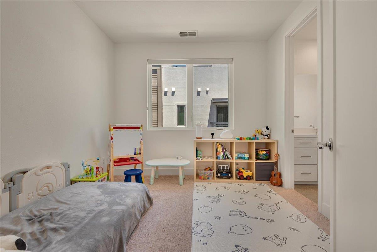7961 Regional Common Dublin, CA 94568 - Photo 22 of 40 a bedroom with a bed and a dresser with mirror
