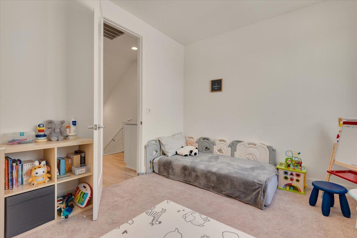 7961 Regional Common Dublin, CA 94568 - Photo 23 of 40 a bedroom with furniture and a book shelf