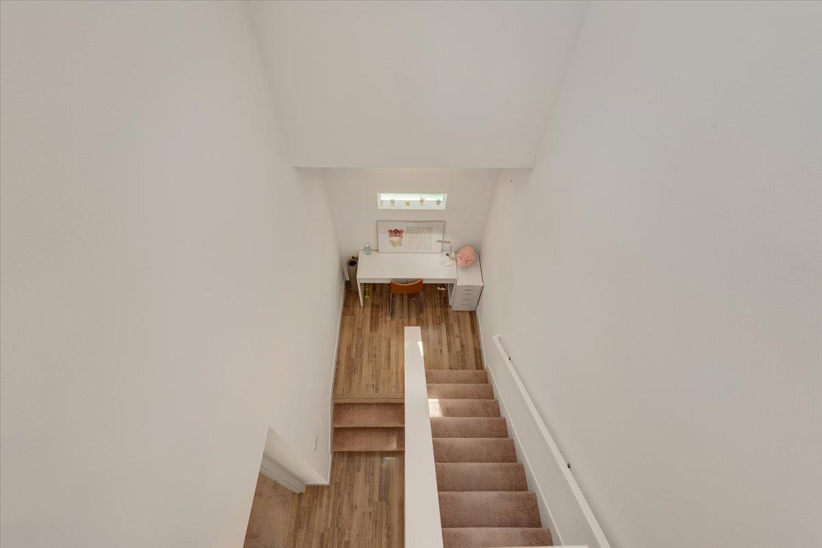 7961 Regional Common Dublin, CA 94568 - Photo 28 of 40 a view of a hallway with wooden floor and staircase