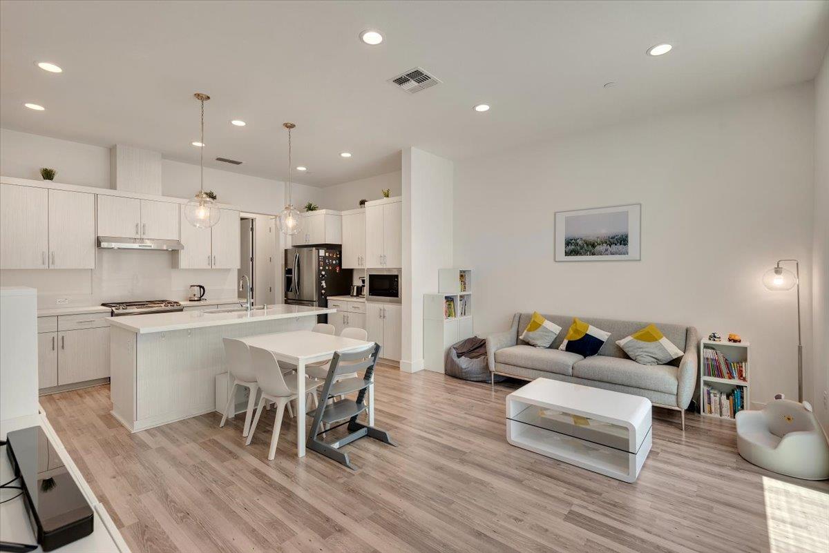 7961 Regional Common Dublin, CA 94568 - Photo 5 of 40 a living room with stainless steel appliances furniture and wooden floor