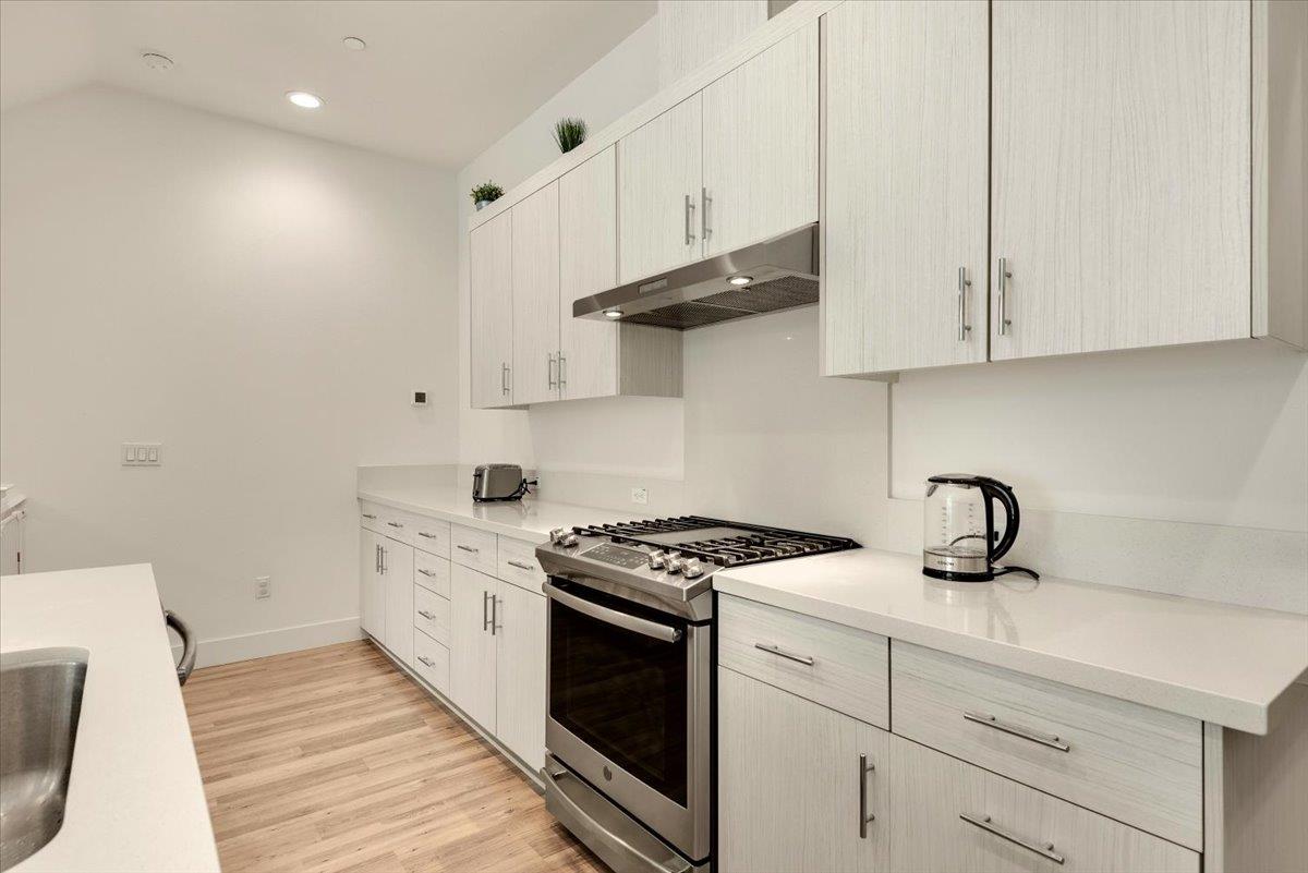 7961 Regional Common Dublin, CA 94568 - Photo 8 of 40 a kitchen with granite countertop a sink a stove and cabinets