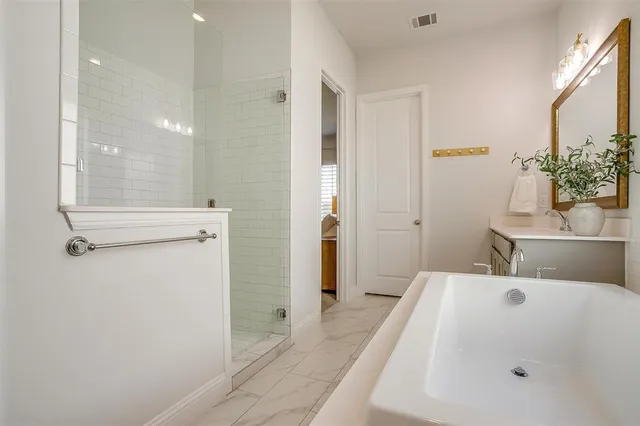 a bathroom with a tub and shower