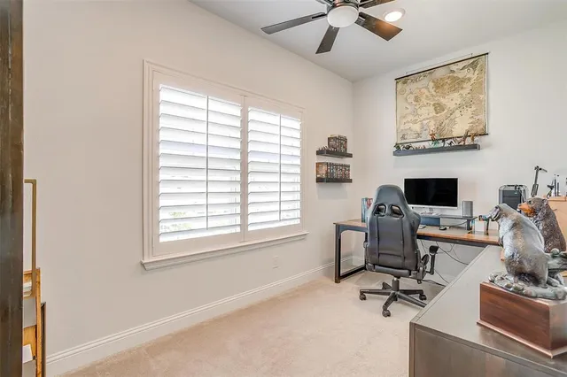 a view of a workspace with furniture and a window