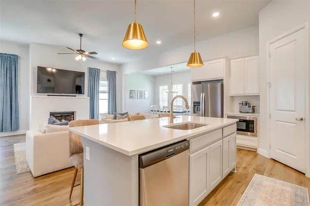 a kitchen with a sink a counter top space and stainless steel appliances