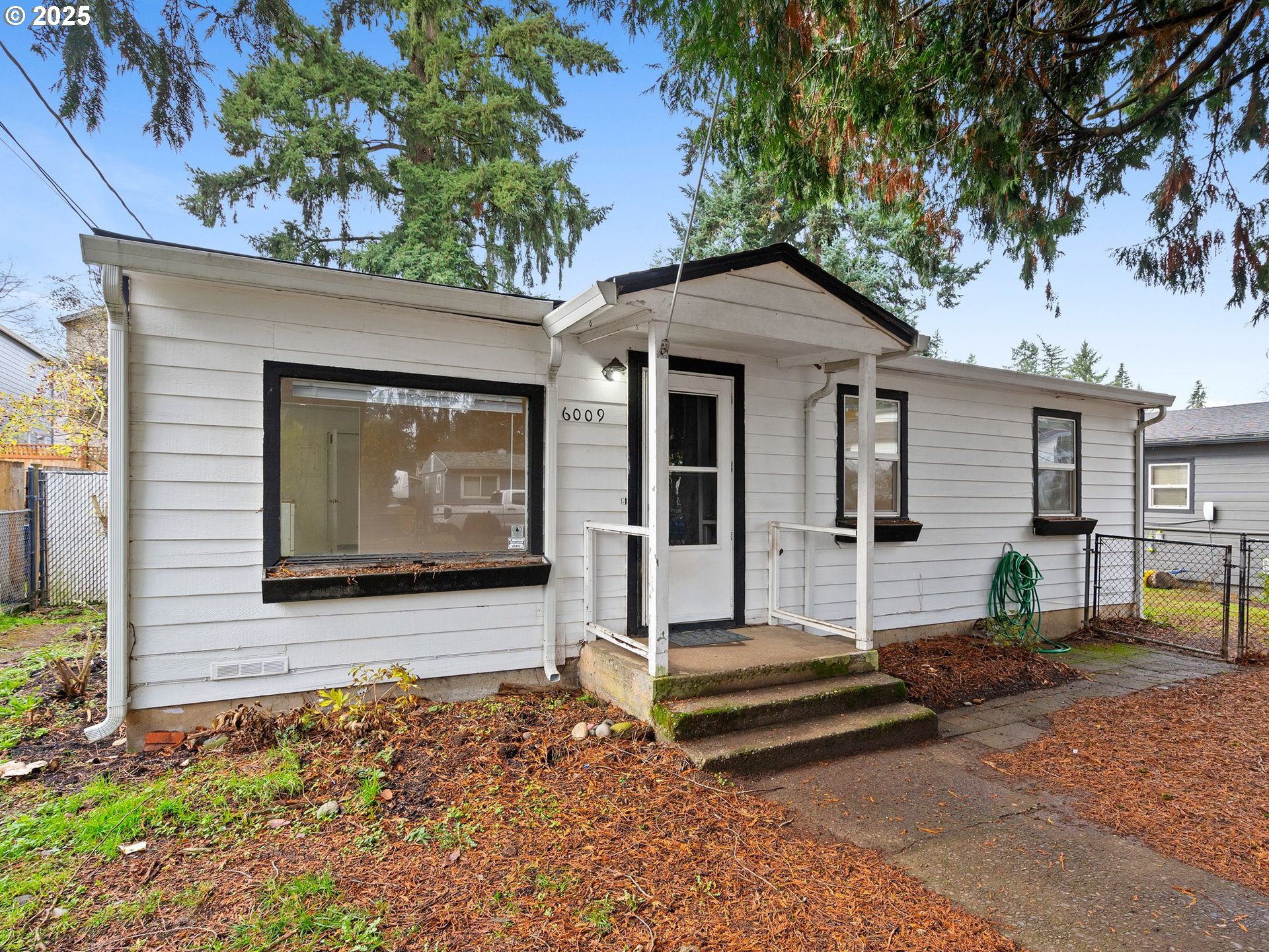6009 Southeast 138th Place Portland, OR 97236 - Photo 1 of 37 a front view of a house with garden