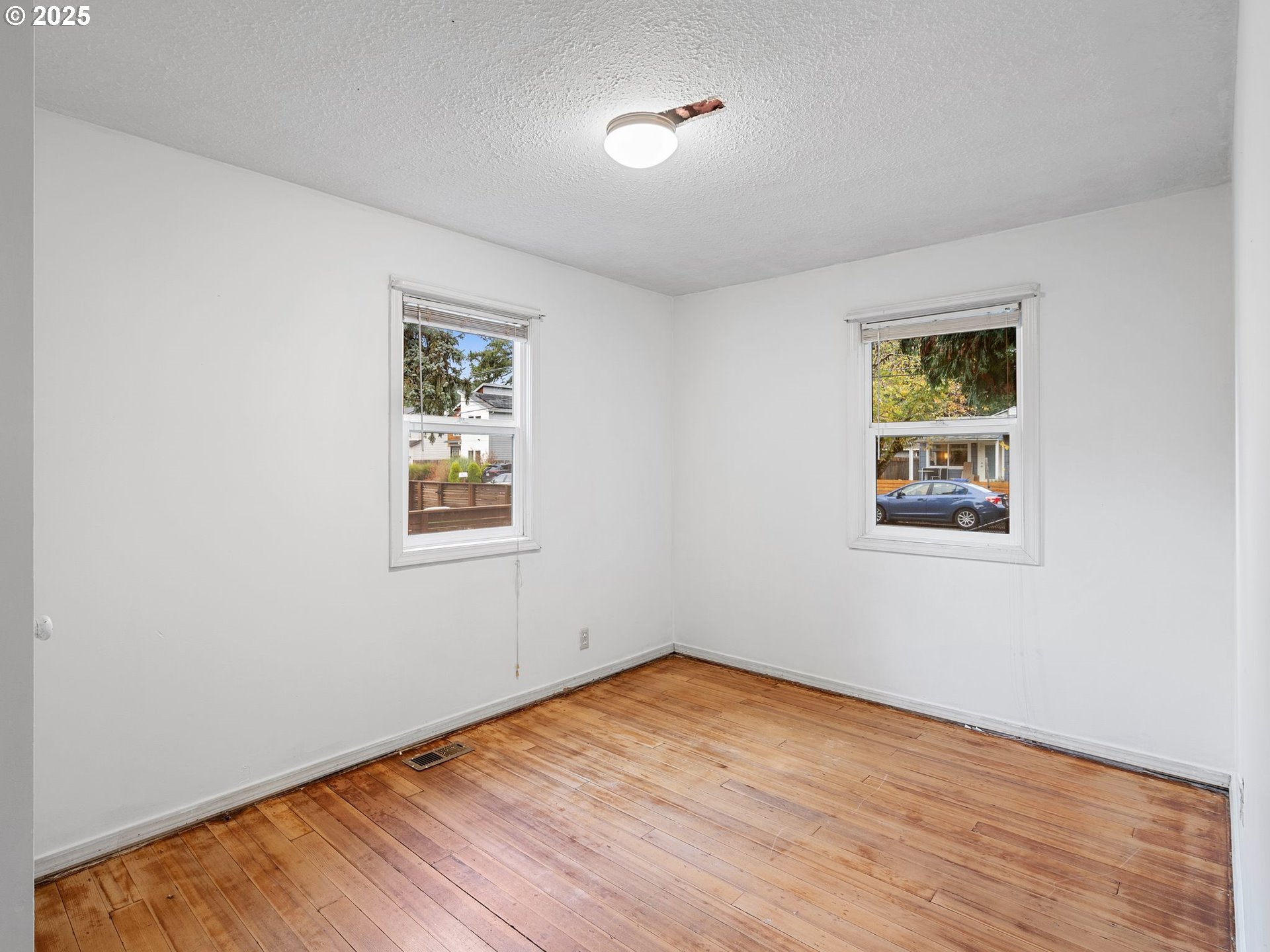 6009 Southeast 138th Place Portland, OR 97236 - Photo 11 of 37 a view of empty room with wooden floor and fan