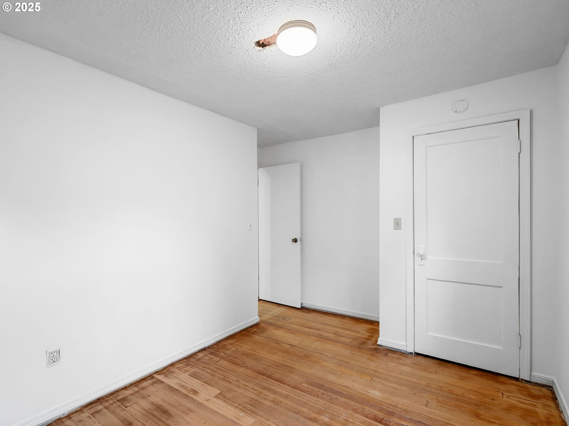 6009 Southeast 138th Place Portland, OR 97236 - Photo 12 of 37 a view of a room with wooden floor