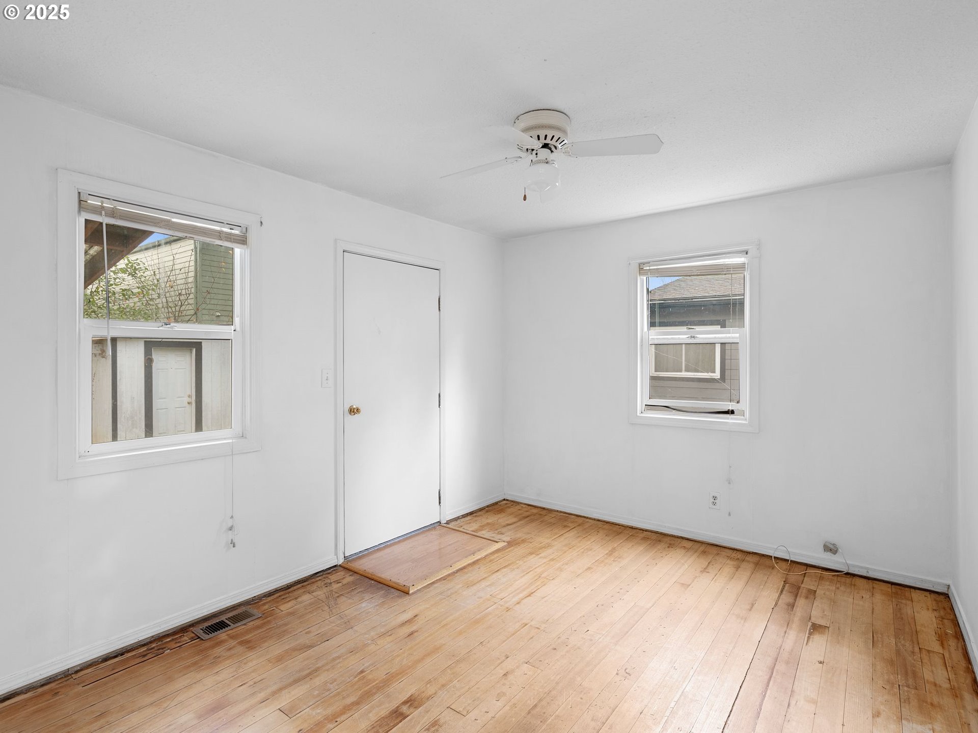 6009 Southeast 138th Place Portland, OR 97236 - Photo 13 of 37 a view of empty room with wooden floor and fan