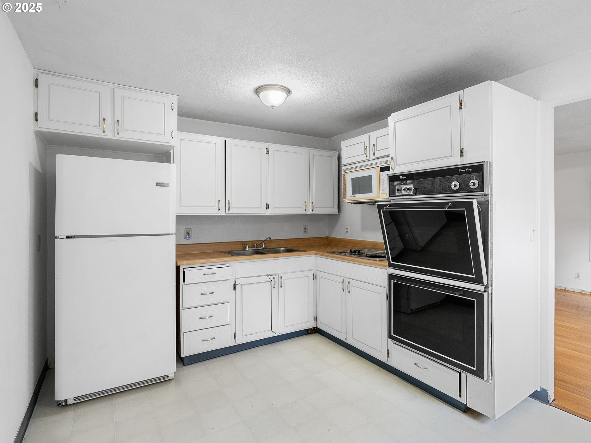 6009 Southeast 138th Place Portland, OR 97236 - Photo 15 of 37 a kitchen with cabinets stainless steel appliances and a counter space