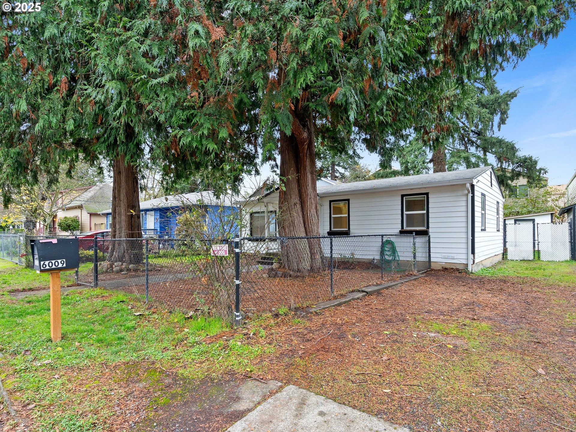 6009 Southeast 138th Place Portland, OR 97236 - Photo 19 of 37 a front view of a house with garden and patio