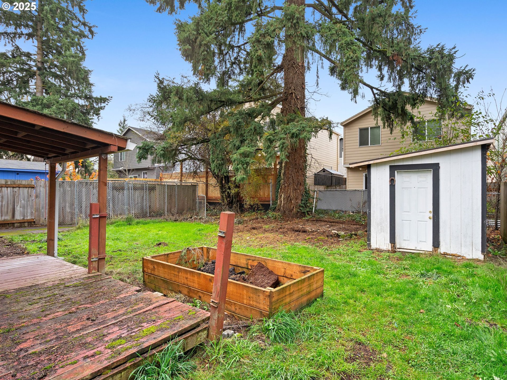 6009 Southeast 138th Place Portland, OR 97236 - Photo 22 of 37 a view of a backyard with wooden fence