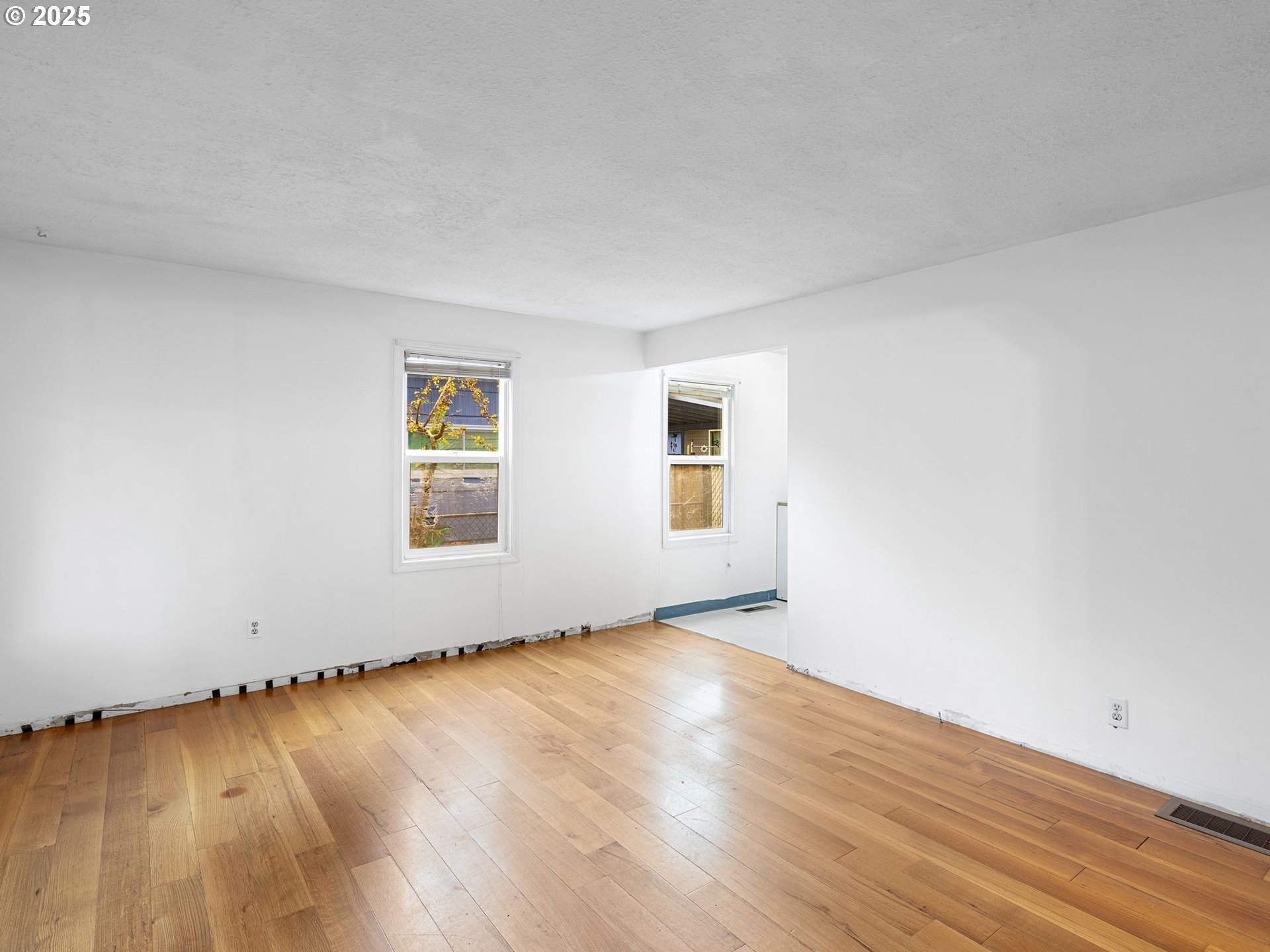 6009 Southeast 138th Place Portland, OR 97236 - Photo 4 of 37 an empty room with wooden floor and windows