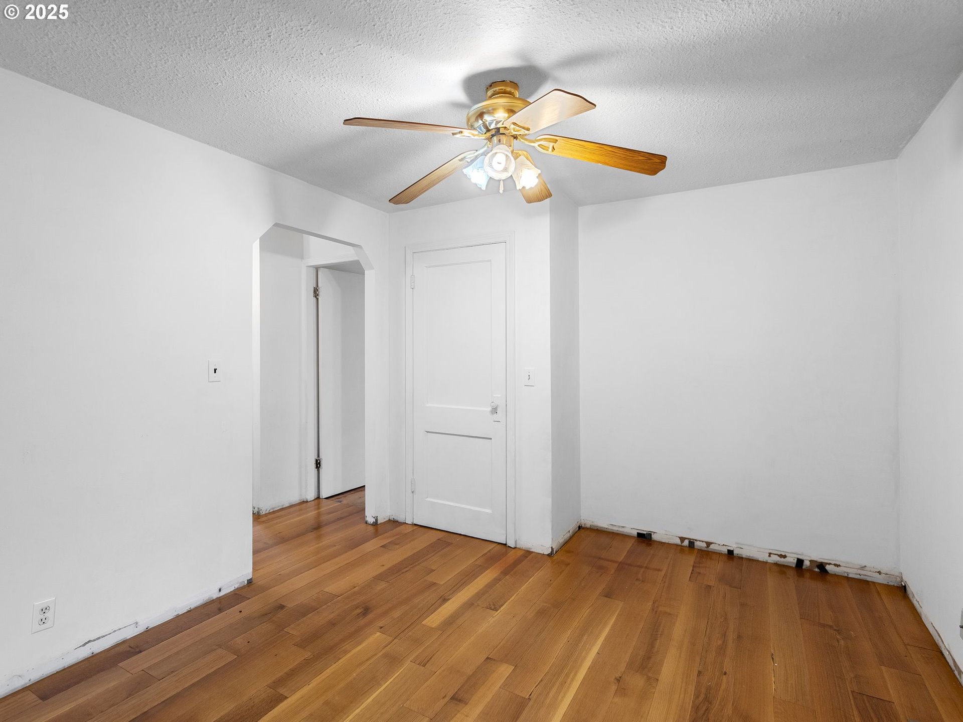 6009 Southeast 138th Place Portland, OR 97236 - Photo 7 of 37 a view of a room with wooden floor and fan
