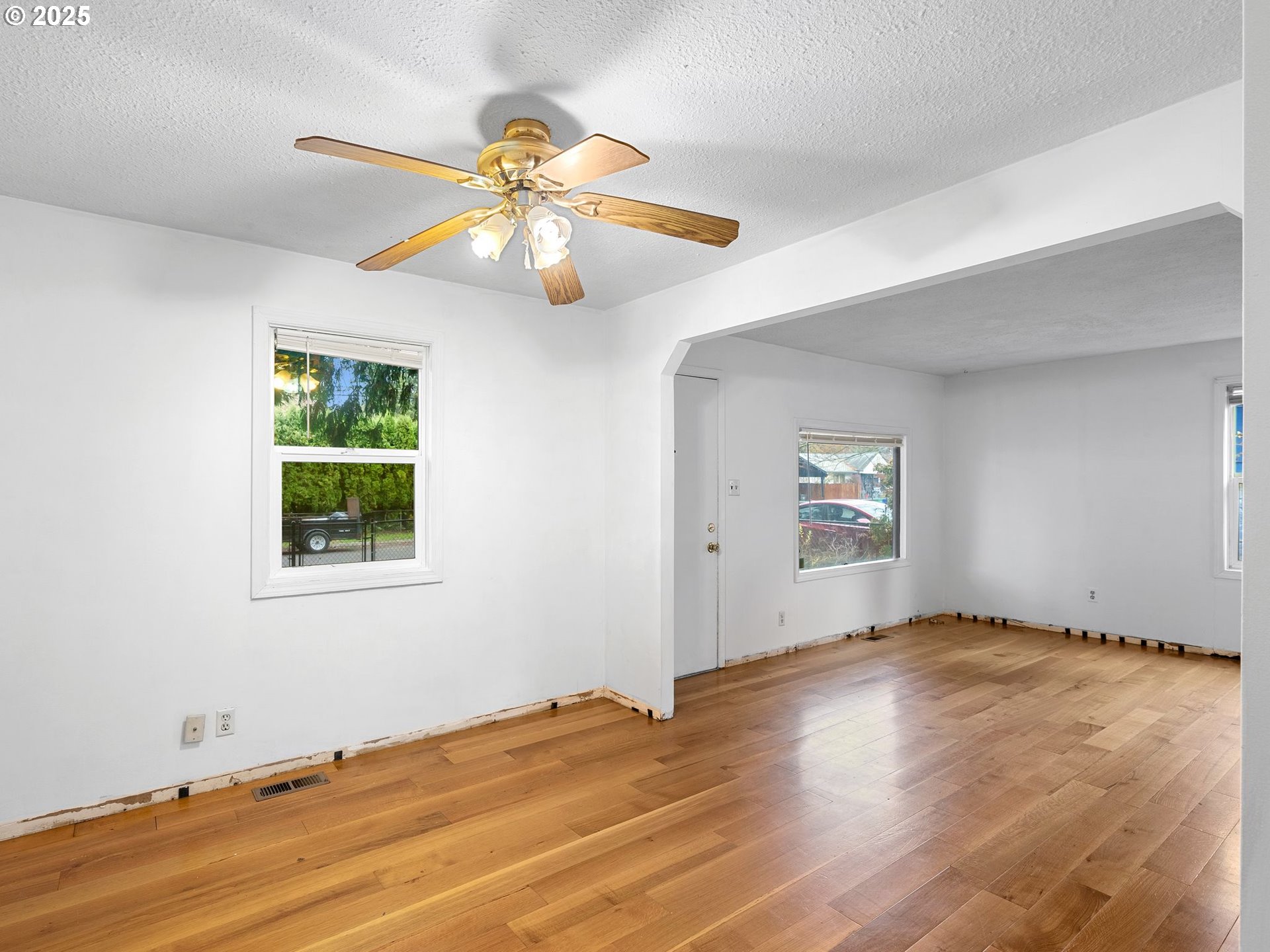 6009 Southeast 138th Place Portland, OR 97236 - Photo 9 of 37 a view of an empty room with window and wooden floor