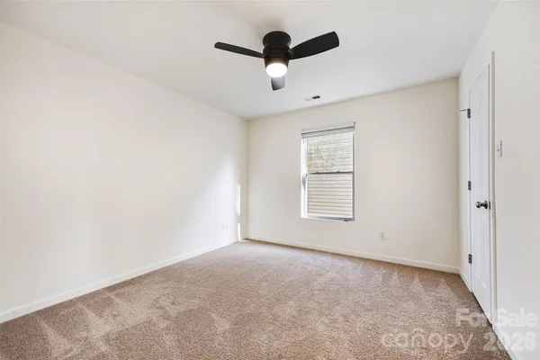 a view of empty room with ceiling fan
