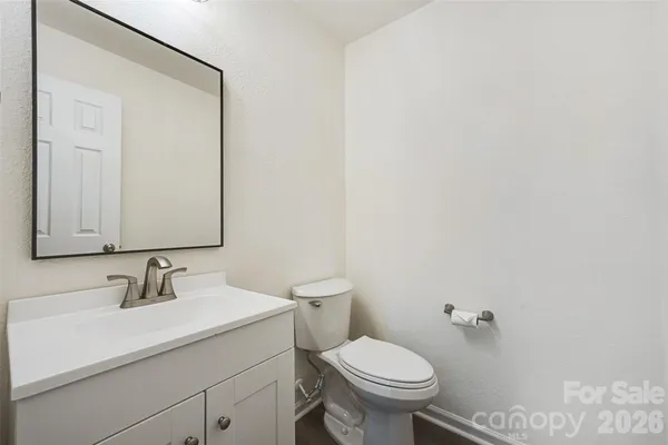 a bathroom with a sink toilet and mirror