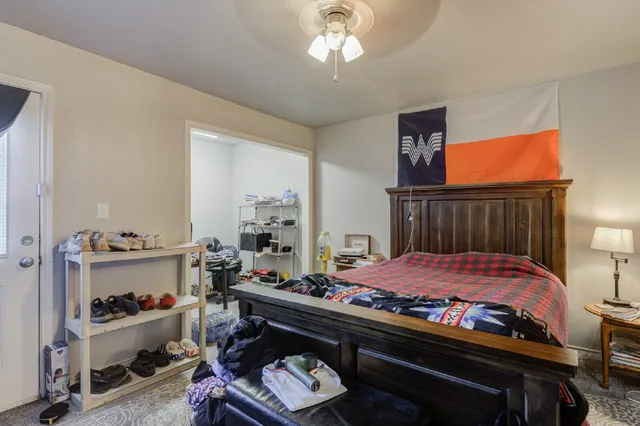 a bed room with a bed and a television