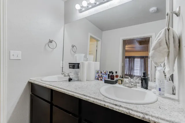 a bathroom with a sink double vanity and a mirror