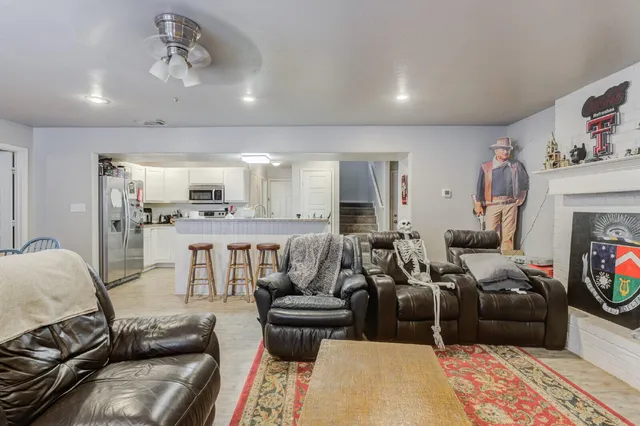 a living room with furniture and a fireplace