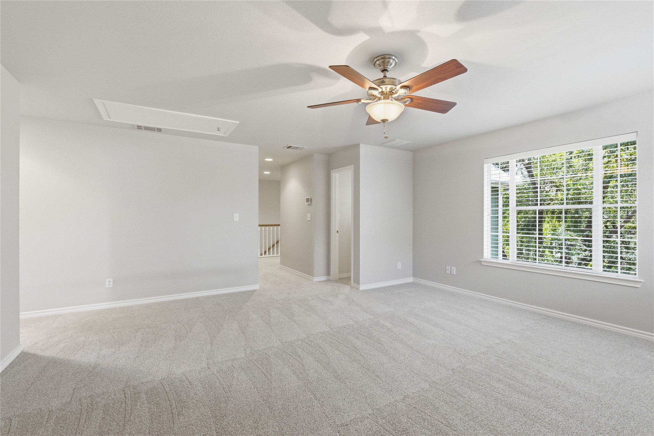 1204 Orlando Road Austin, TX 78733 - Photo 39 of 40 A spacious and inviting living area awaits, offering a comfortable retreat with plush carpeting and natural light.