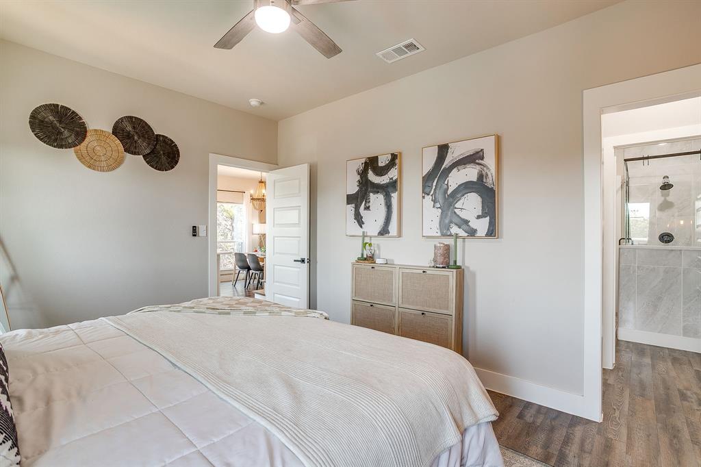 9720 Scenic View Court Rio Vista, TX 76093 - Photo 14 of 31 a bedroom with a large bed and a chandelier