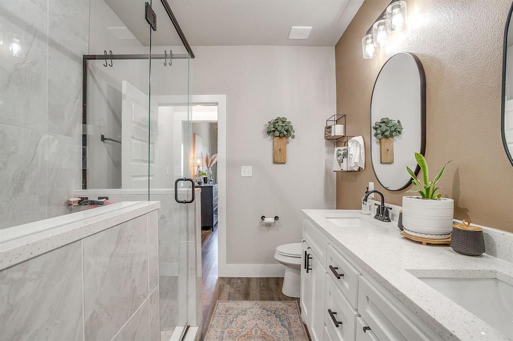 9720 Scenic View Court Rio Vista, TX 76093 - Photo 16 of 31 a bathroom with a granite countertop sink a toilet and shower